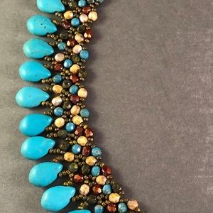 Hand beaded.  All glass bead with Magnesite drops.